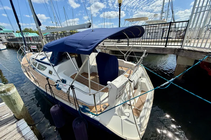 Slide: The Image of 2004 Jeanneau Sun Odyssey 35 sailboat docked at marina under blue sky. - 6