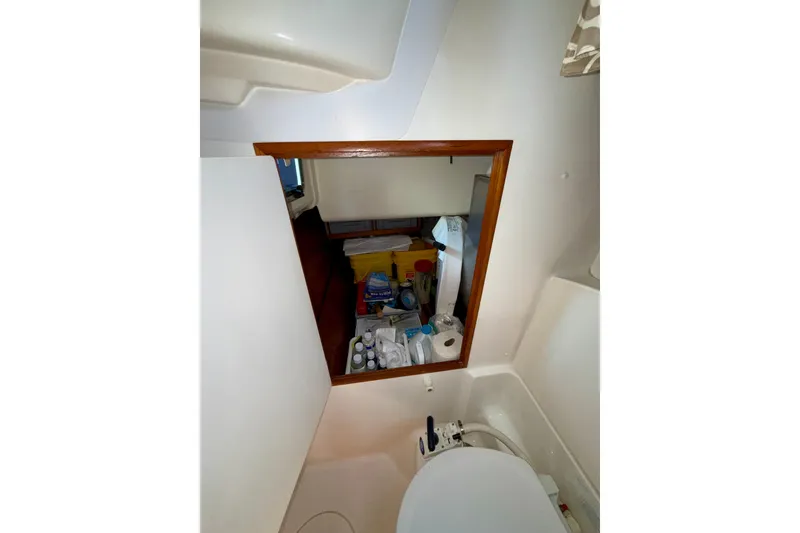 Slide: The Image of Interior view of 2004 Jeanneau Sun Odyssey 35 sailboat bathroom with storage area. - 61