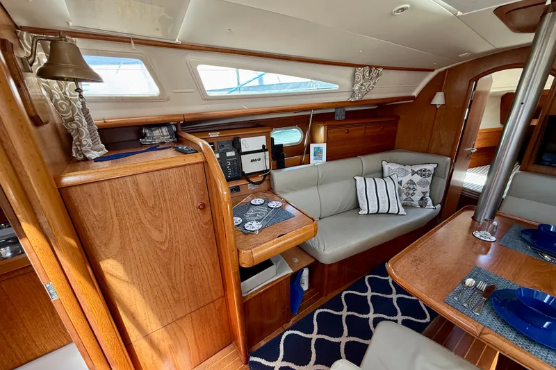 Slide: The Image of Interior of 2004 Jeanneau Sun Odyssey 35 sailboat with cozy seating and elegant wood finish. - 63