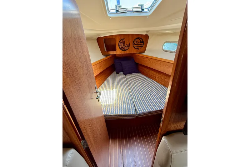 Slide: The Image of Cozy cabin interior of 2004 Jeanneau Sun Odyssey 35 sailboat with wooden finish. - 72