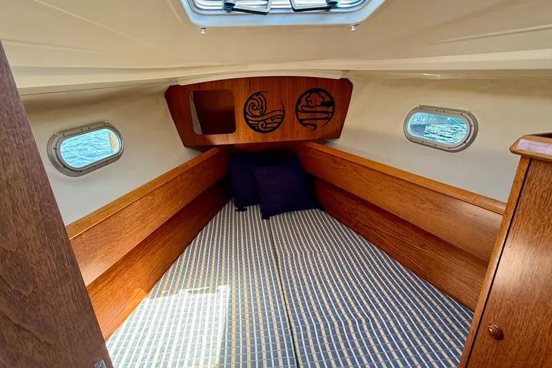 Slide: The Image of Interior cabin of 2004 Jeanneau Sun Odyssey 35 sailboat with wooden finish and nautical decor. - 73