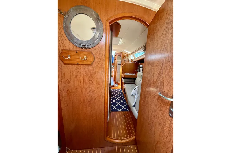 Slide: The Image of Interior view of 2004 Jeanneau Sun Odyssey 35 sailboat, featuring wooden finishes and nautical decor. - 76