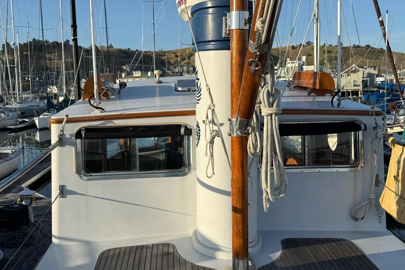 Slide: The Image of 1987 Lord Nelson Victory Tug docked in a marina, showcasing its classic design. - 11