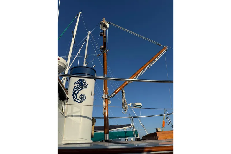 Slide: The Image of 1987 Lord Nelson Victory Tug with seahorse emblem against clear blue sky. - 13