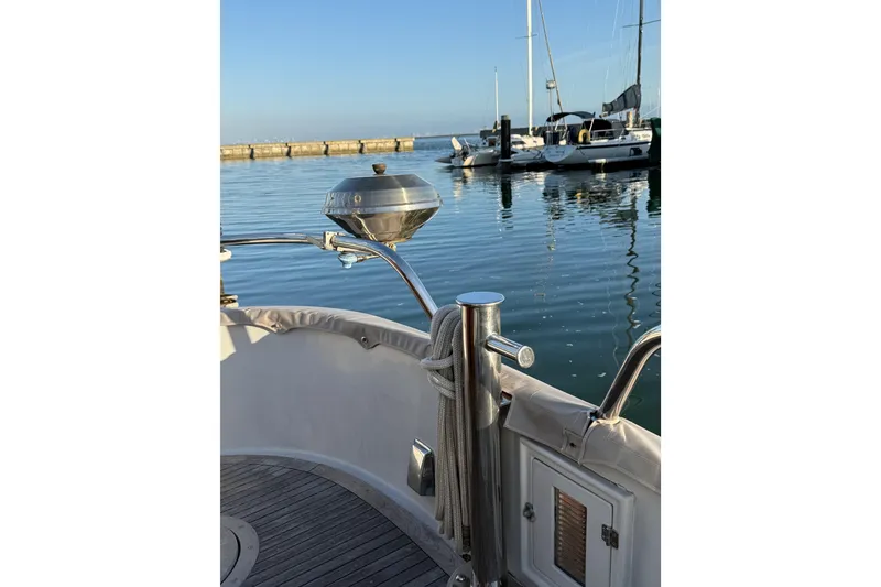 Slide: The Image of 1987 Lord Nelson Victory Tug docked in a serene marina setting. - 18