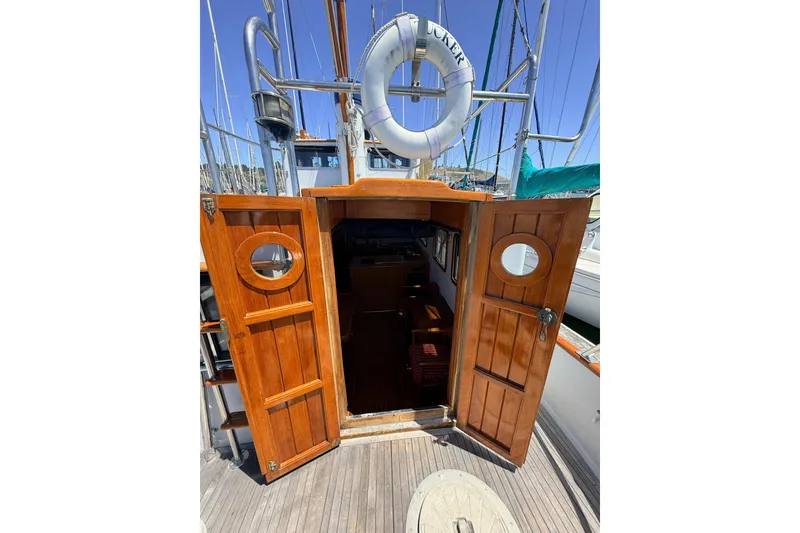 Slide: The Image of Wooden cabin doors open on a 1987 Lord Nelson Victory Tug boat deck. - 19
