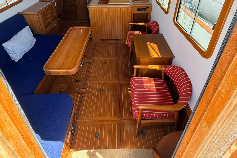 Slide: The Image of Interior of 1987 Lord Nelson Victory Tug with wooden furnishings and striped chairs. - 20