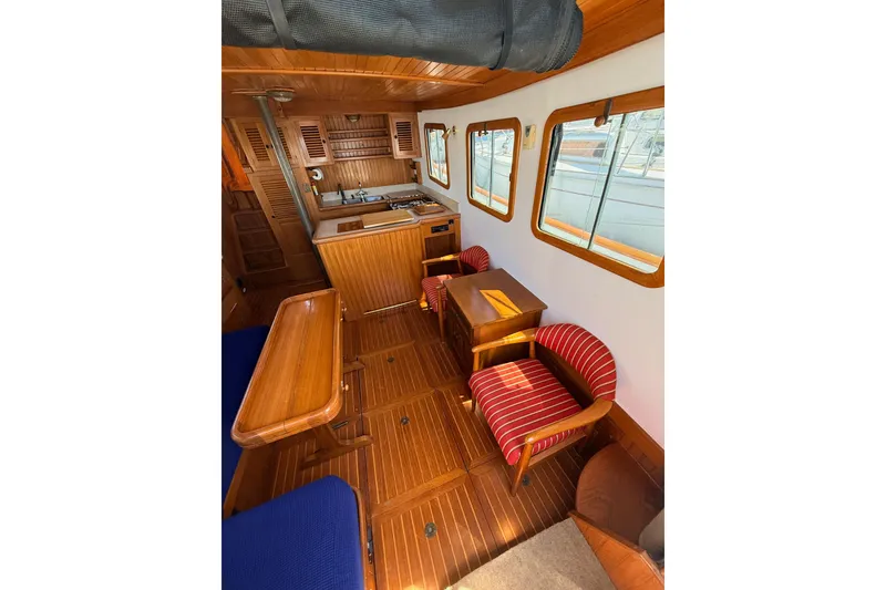Slide: The Image of Interior of 1987 Lord Nelson Victory Tug with wooden furnishings and striped chairs. - 22