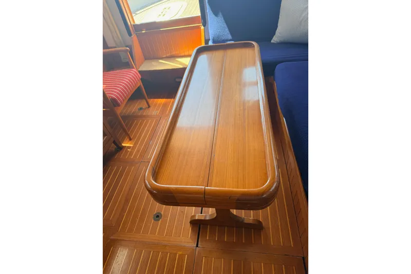 Slide: The Image of Wooden table inside 1987 Lord Nelson Victory Tug, featuring elegant nautical design. - 23