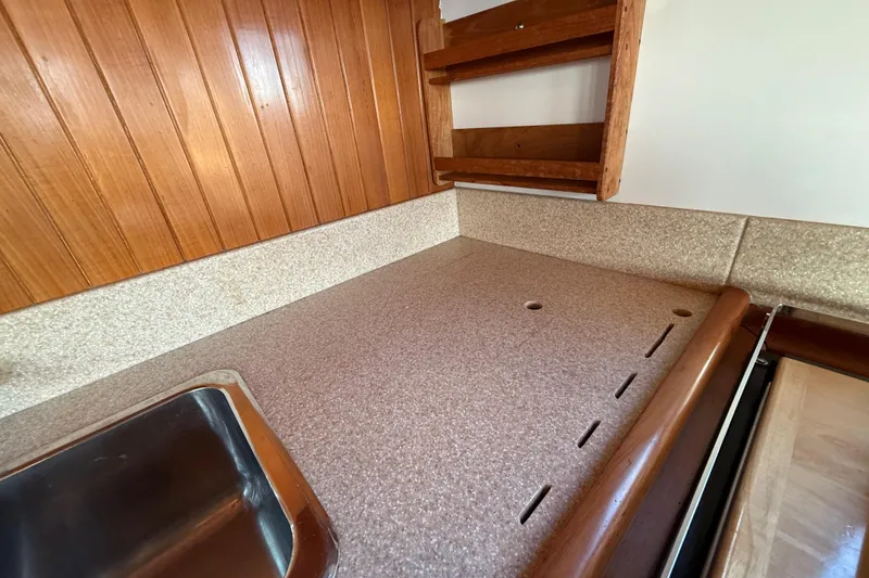 Slide: The Image of 1987 Lord Nelson Victory Tug kitchen with wooden paneling and countertop. - 30