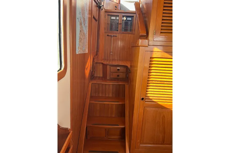 Slide: The Image of Interior of 1987 Lord Nelson Victory Tug with wooden stairs and cabinetry. - 31