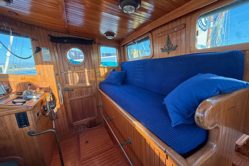 Slide: The Image of Cozy wooden interior of 1987 Lord Nelson Victory Tug with blue cushioned seating. - 32
