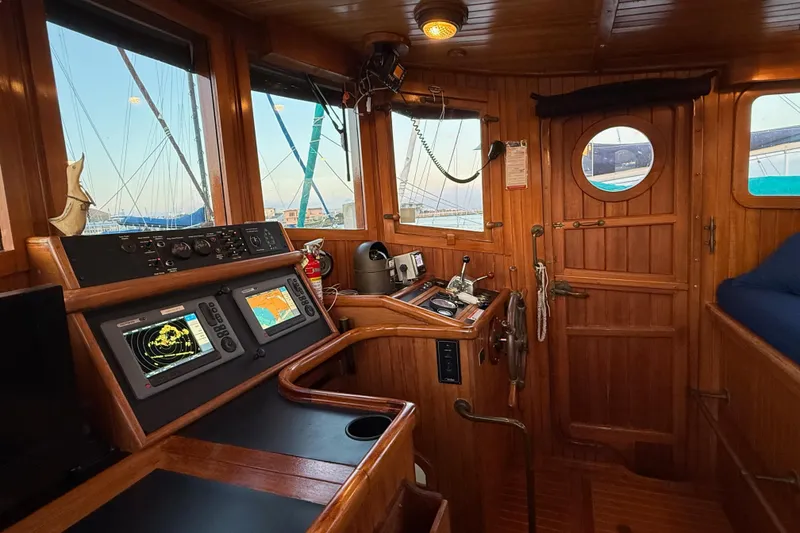 Slide: The Image of Cozy 1987 Lord Nelson Victory Tug interior with navigation equipment and wooden finish. - 33