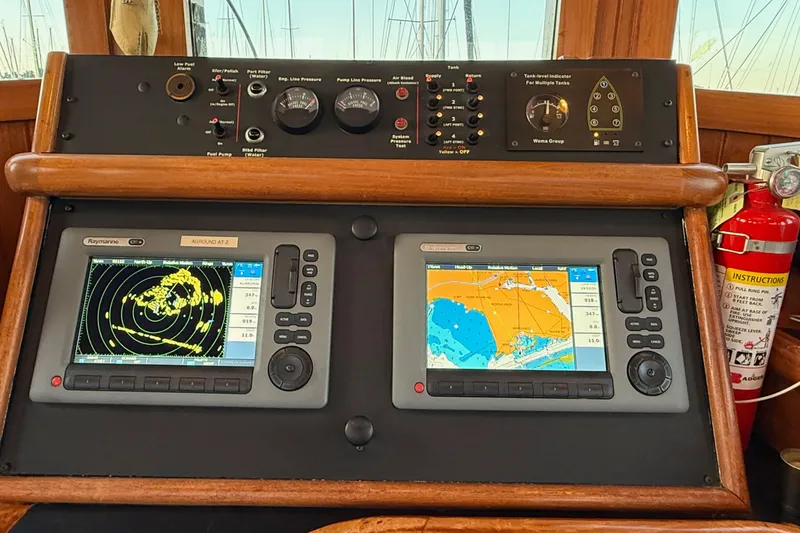 Slide: The Image of Control panel of a 1987 Lord Nelson Victory Tug with navigation screens and fire extinguisher. - 35