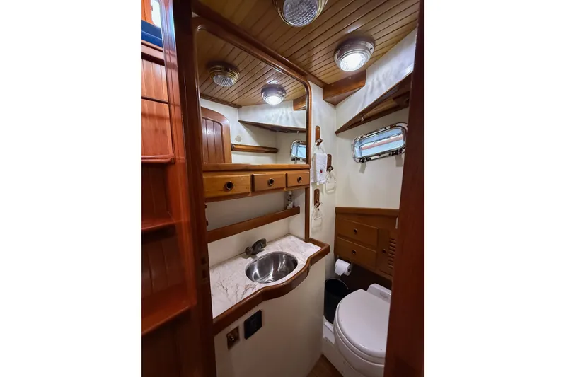 Slide: The Image of 1987 Lord Nelson Victory Tug bathroom with wooden cabinetry and stainless steel sink. - 37