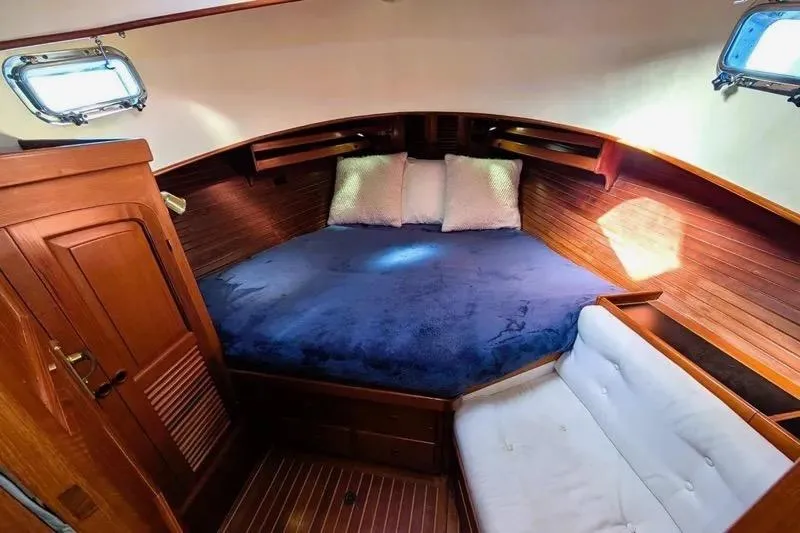 Slide: The Image of Cozy cabin interior of 1987 Lord Nelson Victory Tug with wooden finish and blue bedding. - 38