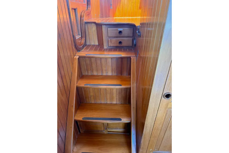 Slide: The Image of Wooden staircase inside 1987 Lord Nelson Victory Tug boat, featuring built-in drawers. - 41