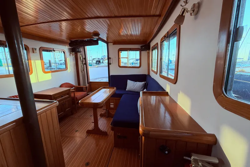 Slide: The Image of Cozy interior of 1987 Lord Nelson Victory Tug with wooden furnishings and blue seating. - 43