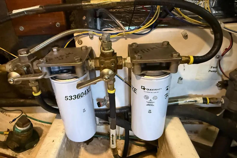 Slide: The Image of Engine room of 1987 Lord Nelson Victory Tug with dual fuel filters and hoses. - 47