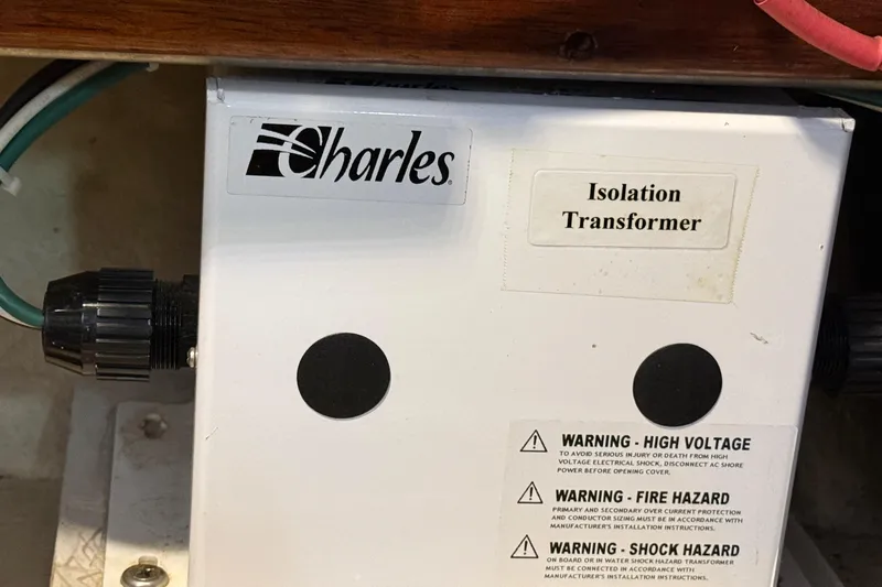 Slide: The Image of Charles isolation transformer with safety warnings on a 1987 Lord Nelson Victory Tug. - 49