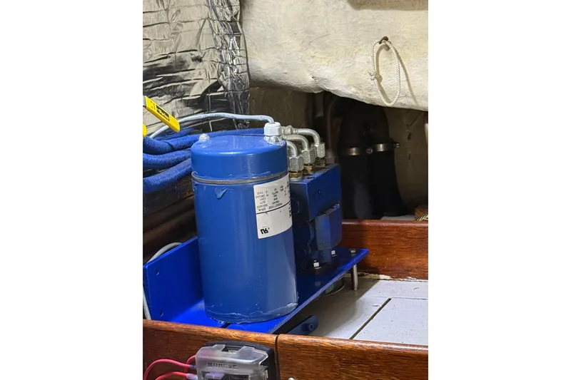 Slide: The Image of Engine compartment of 1987 Lord Nelson Victory Tug with blue machinery and wiring. - 52