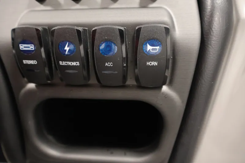 Slide: The Image of Control panel switches on a 2026 Bentley Pontoons 220 Navigator boat. - 25