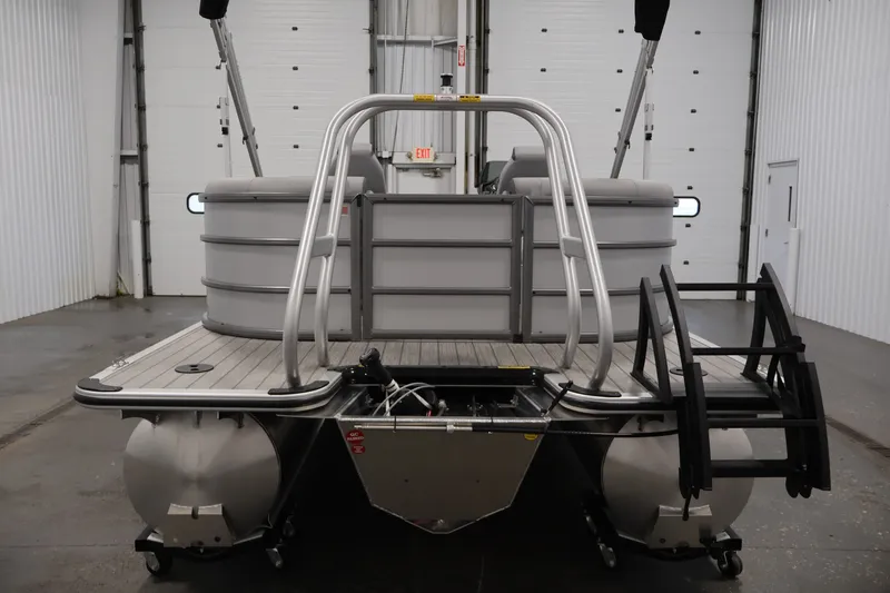 Slide: The Image of 2026 Bentley Pontoons 220 Navigator in a warehouse, rear view with ladder and railing. - 8