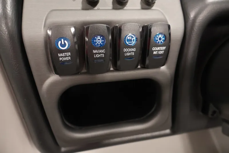 Slide: The Image of Control panel of 2026 Bentley Pontoons 220 Navigator with power and light switches. - 24