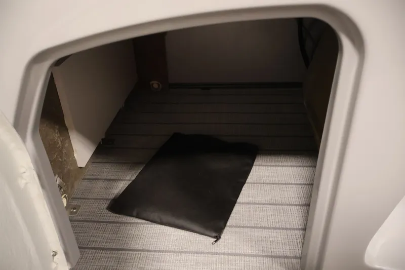 Slide: The Image of Interior storage compartment of 2026 Bentley Pontoons 220 Navigator with black mat. - 20