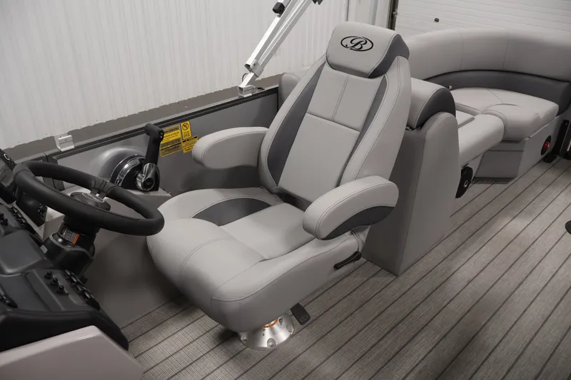 Slide: The Image of 2026 Bentley Pontoons 220 Navigator interior with luxurious captain's chair and steering console. - 29