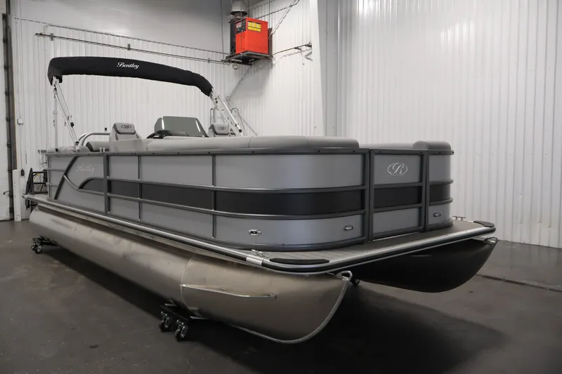 Slide: The Image of 2026 Bentley Pontoons 220 Navigator in a showroom, showcasing sleek design and modern features. - 5