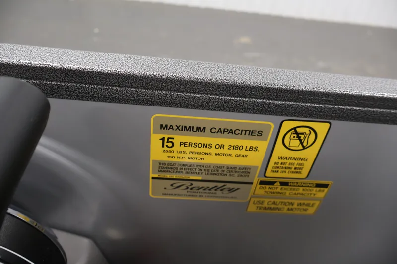 Slide: The Image of 2026 Bentley Pontoons 220 Navigator capacity label, 15 persons or 2180 lbs, safety warnings. - 28