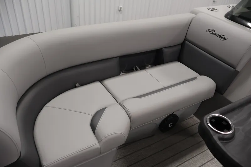 Slide: The Image of 2026 Bentley Pontoons 220 Navigator interior with luxurious gray seating and cup holders. - 16