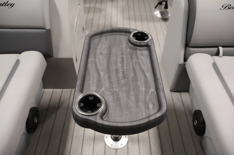 Slide: The Image of 2026 Bentley Pontoons 220 Navigator interior with sleek table and cup holders. - 18
