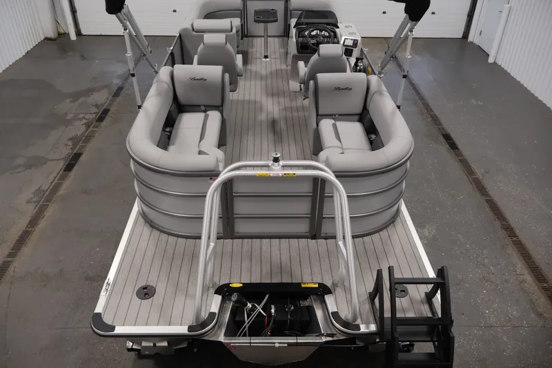 Slide: The Image of 2026 Bentley Pontoons 220 Navigator with spacious seating and modern design in a showroom. - 12