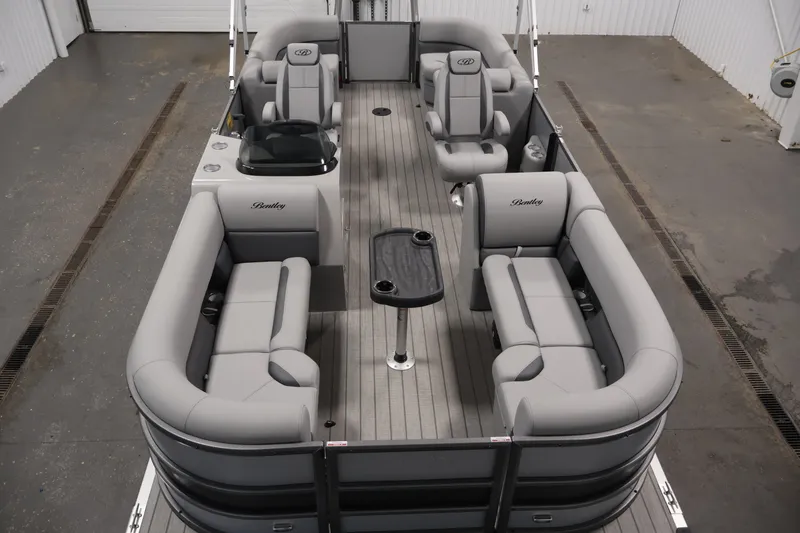 Slide: The Image of 2026 Bentley Pontoons 220 Navigator with spacious seating and sleek design in a showroom. - 11