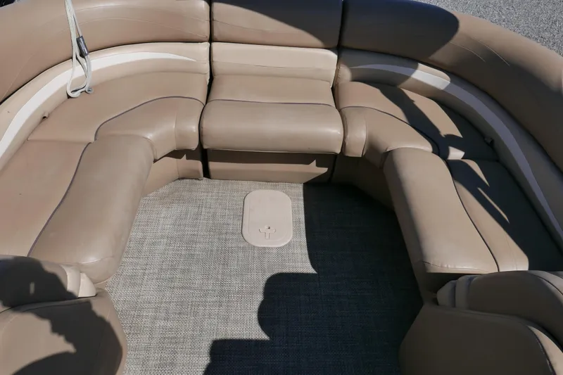 Slide: The Image of 2016 Bennington 2250GSR boat interior with beige seating and carpeted floor. - 10