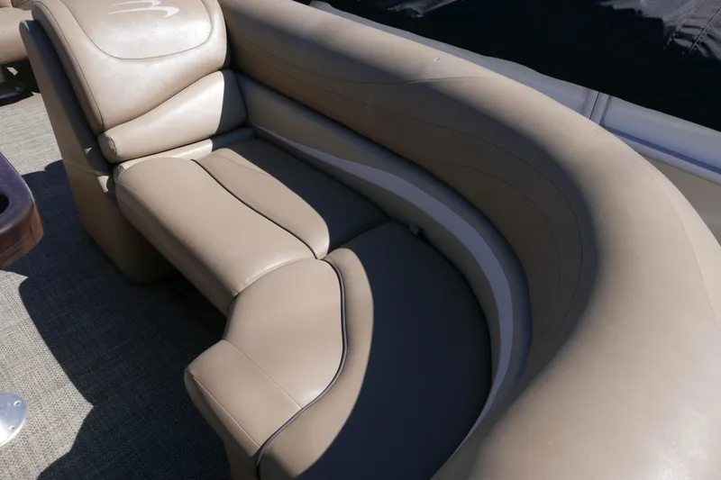 Slide: The Image of Luxurious seating on a 2016 Bennington 2250GSR pontoon boat, featuring plush beige upholstery. - 5