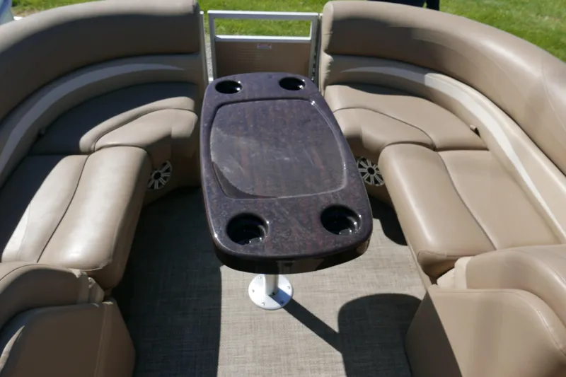 Slide: The Image of 2016 Bennington 2250GSR boat interior with beige seating and a central table. - 6