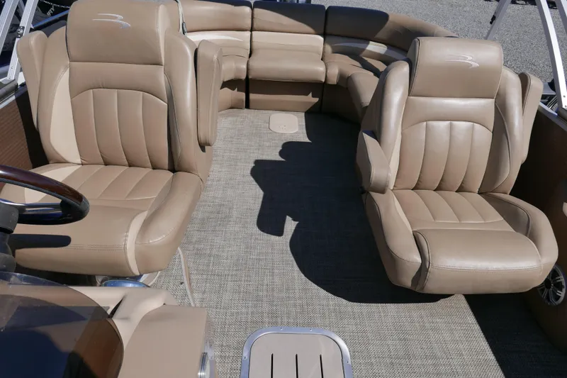 Slide: The Image of 2016 Bennington 2250GSR boat interior with tan leather seating and spacious layout. - 7