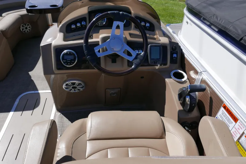 Slide: The Image of 2016 Bennington 2250GSR boat cockpit with steering wheel and control panel. - 9
