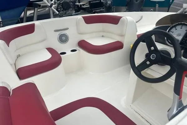 Slide: The Image of 2016 Bayliner 160 Element boat interior with red and white seating and steering wheel. - 6