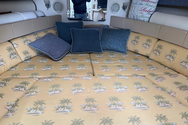 Slide: The Image of Interior of 2004 Wellcraft 330 Coastal boat with tropical-themed bedding and cushions. - 13