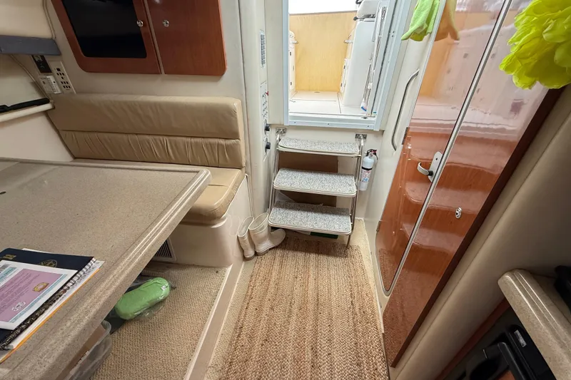 Slide: The Image of Interior of 2004 Wellcraft 330 Coastal boat with seating, table, and stairs. - 20