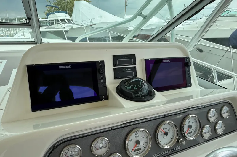 Slide: The Image of Dashboard of a 2004 Wellcraft 330 Coastal boat with Simrad displays and gauges. - 5