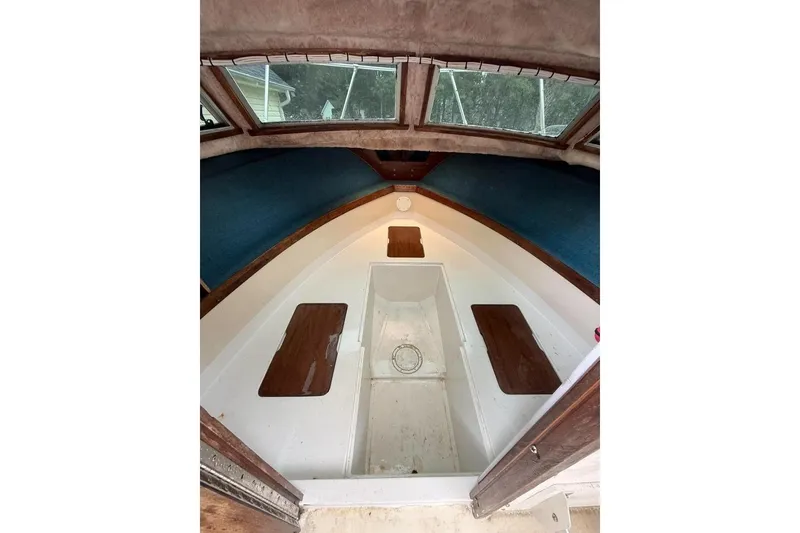 Slide: The Image of Interior of a 1981 Grady-White boat cabin with wooden accents and windows. - 11