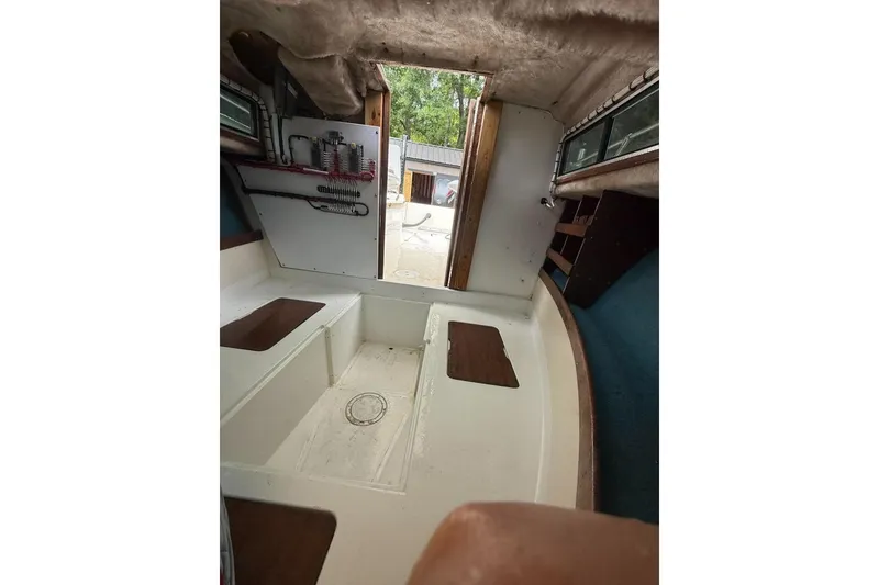 Slide: The Image of Interior view of a 1981 Grady-White boat cabin with seating and storage. - 12