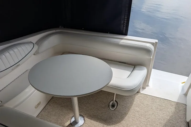 Slide: The Image of Interior seating area of a 2002 Maxum 2700 SCR boat with round table. - 14