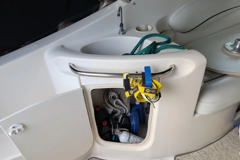 Slide: The Image of 2002 Maxum 2700 SCR boat interior with open storage compartment and sink. - 16
