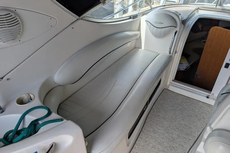 Slide: The Image of Interior of a 2002 Maxum 2700 SCR boat with white seating and carpeted floor. - 17
